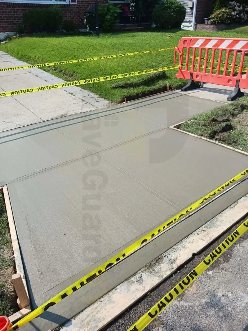 New residential sidewalk slab curing behind caution tape